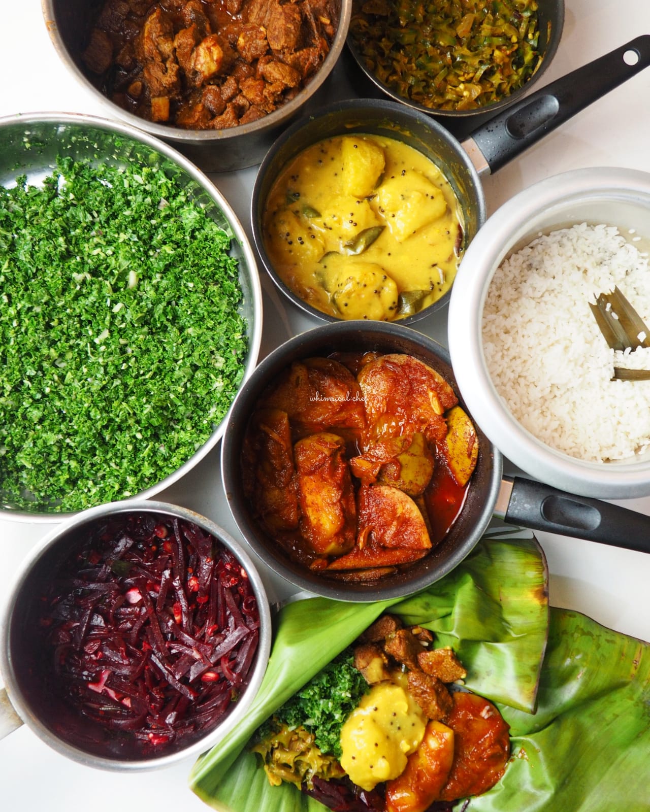 A spread of Sri Lankan rice and curry dishes around a pot of rice